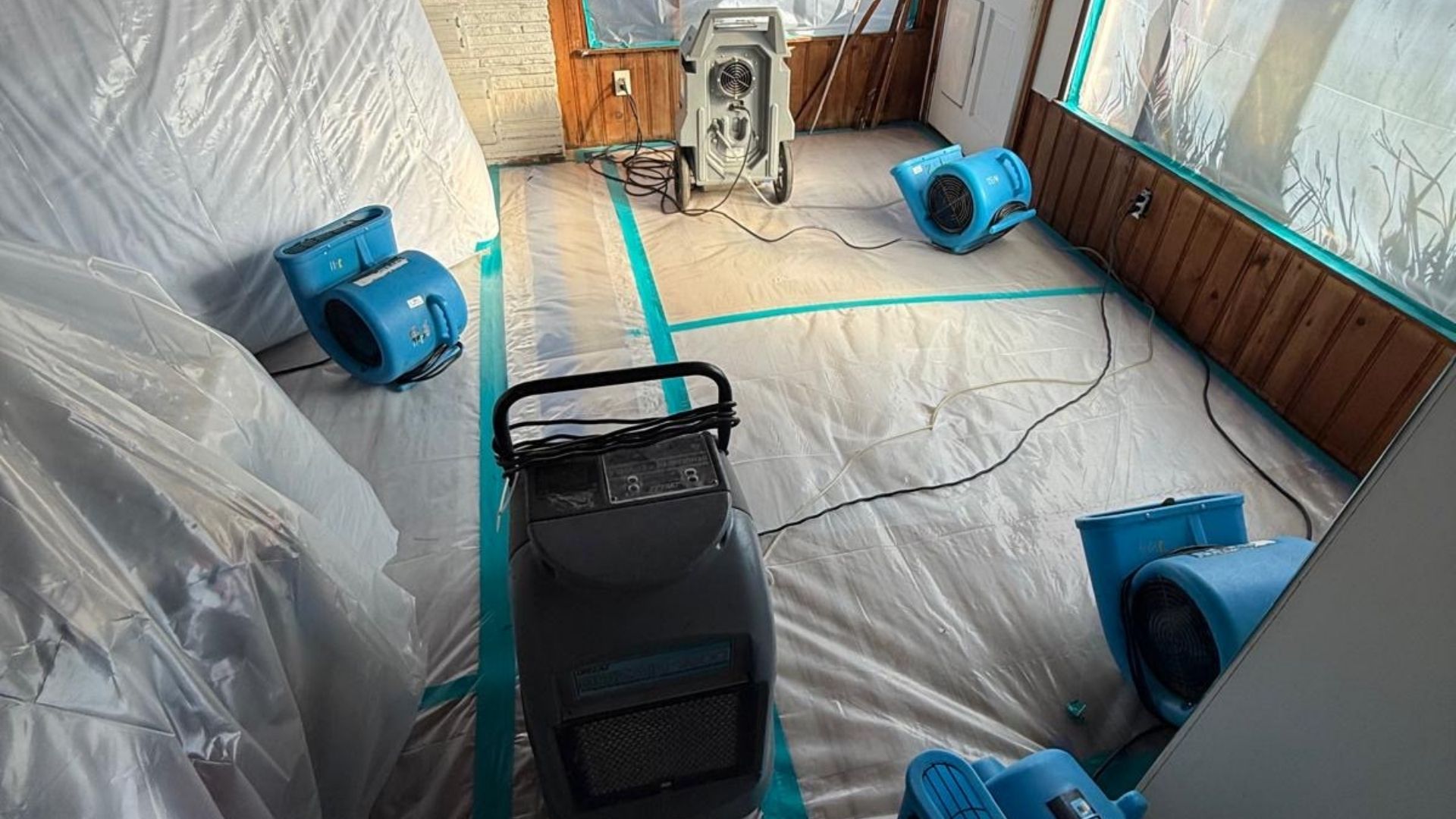 Containment with plastic sheeting and air movers set in a circular airflow pattern